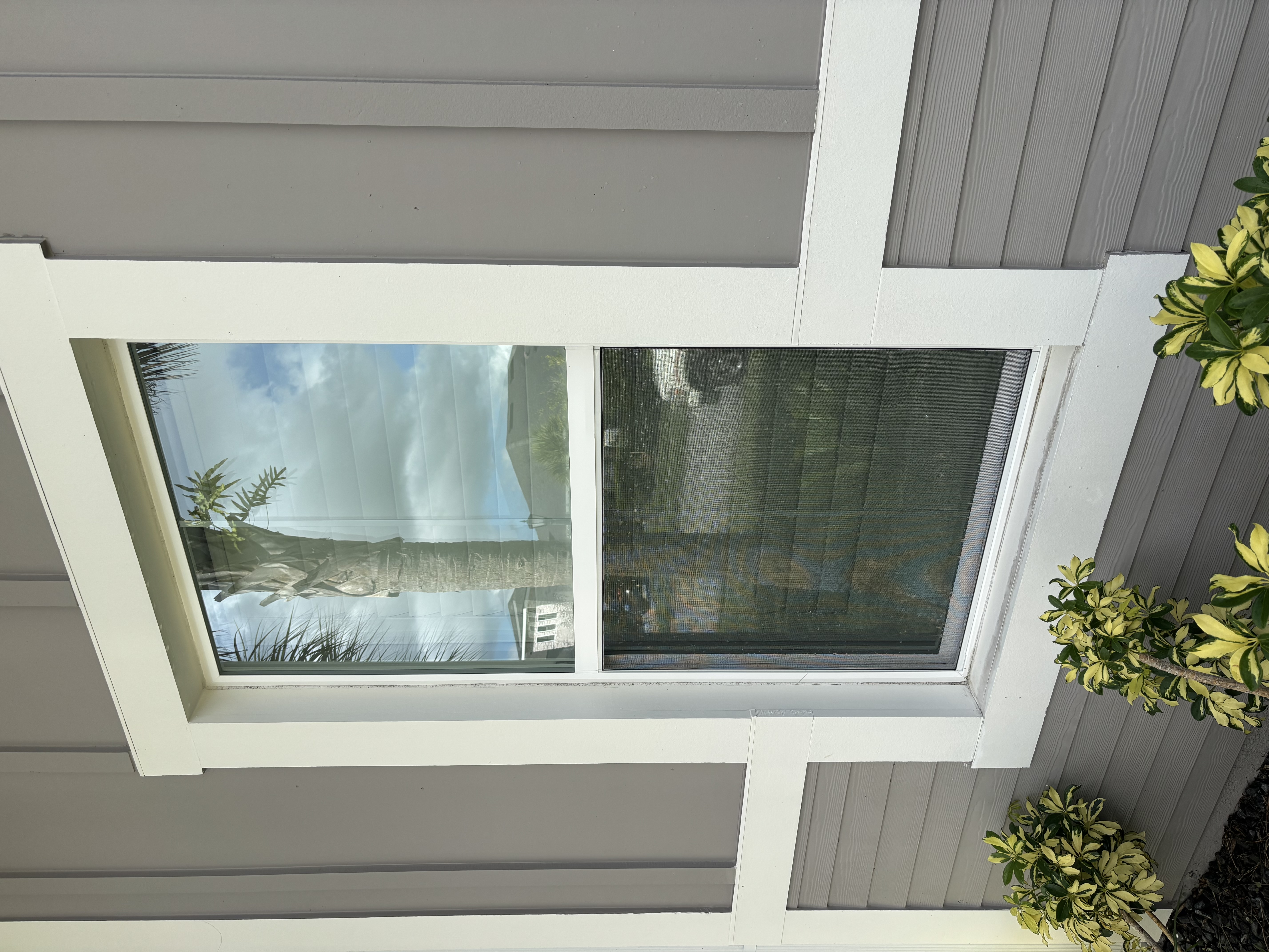 Exterior window with clearer glass and a cleaned frame after washing